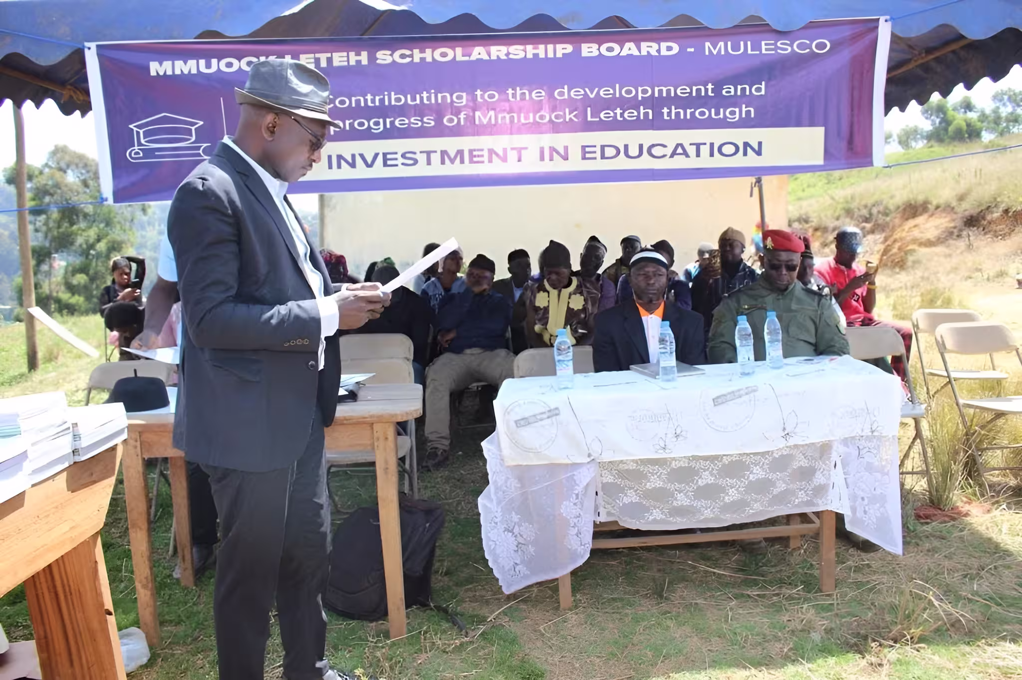 A mulesco team member in a cap and suit reading activity reports